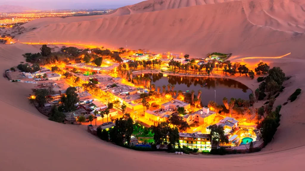 Huacachina oasis surrounded by desert dunes